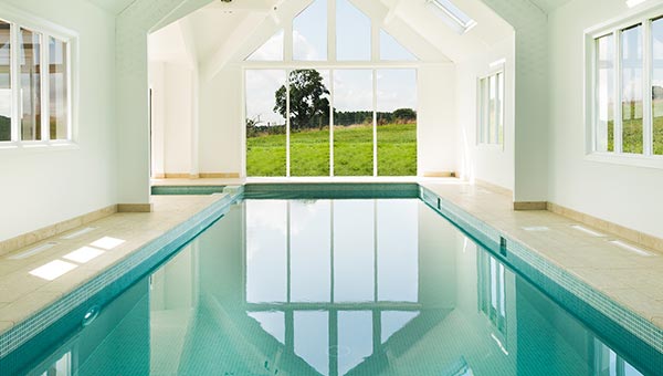 looking out across indoor pool to large window at the end